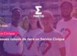 Group of diverse young volunteers smiling outdoors, wearing white shirts with heart ribbons, with THOTIS logo and 'Service Civique' banner in a pink-blue tinted banner.