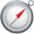 Circular compass with a red needle pointing northeast against a white dial and silver rim